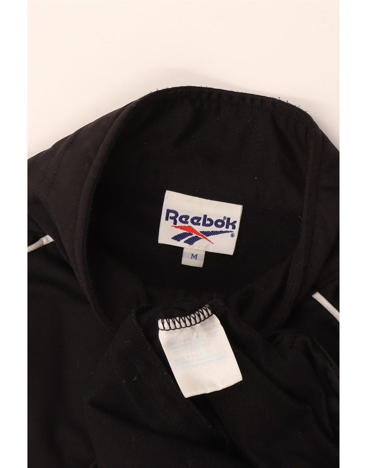 Ανδρική φόρμα με κοντομάνικο γραφικό Reebok Top Jacket Μεσαίο Μαύρο